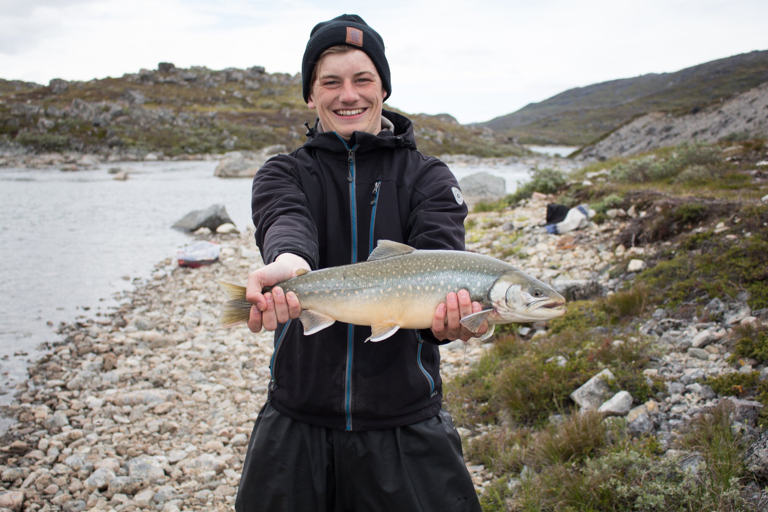A person proudly holding a fish